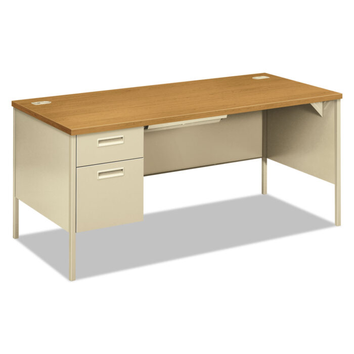 HON Metro Classic Series Left Pedestal Workstation Desk has a durable laminate top that resists marks. It features painted legs, flush end panels, and sleek drawer pulls. The desk has a high-sided file drawer with full-extension slides for easy access and a box drawer that extends three-quarters with smooth rollers. Its center drawer locks have a "One Key" system for security. There are also grommets for managing cables and a modesty panel for privacy. The desk has a rectangular shape and comes in a Harvest/Putty color combination, which has an oak-like finish.